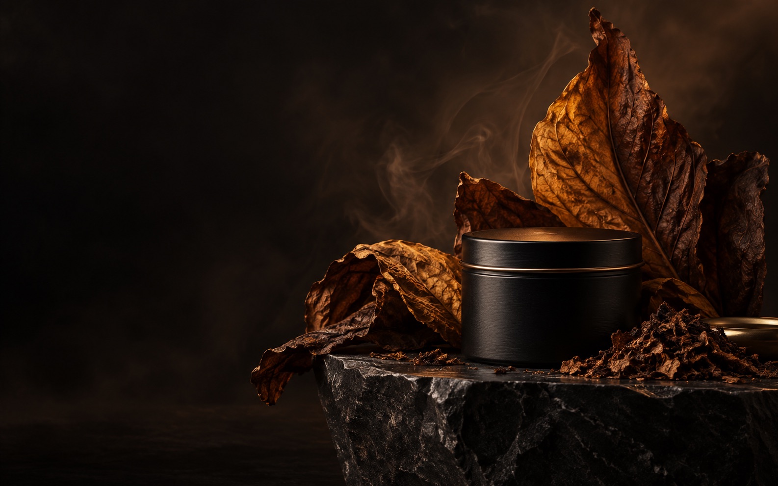 Sculptural cured tobacco leaves surrounding a matte black Elanor tin